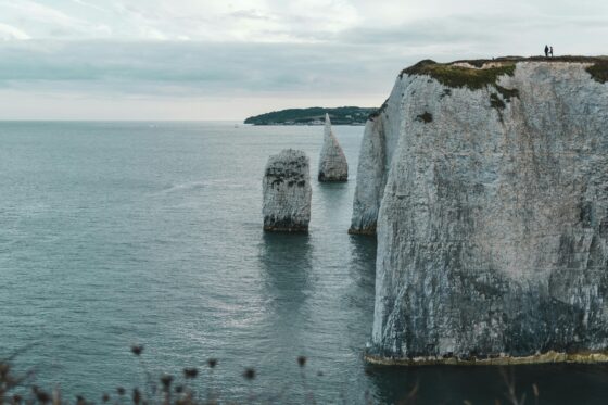 A breathtaking view of Old Harry Rocks on the Dorset coastline showcasing natural sea stacks and cliffs.